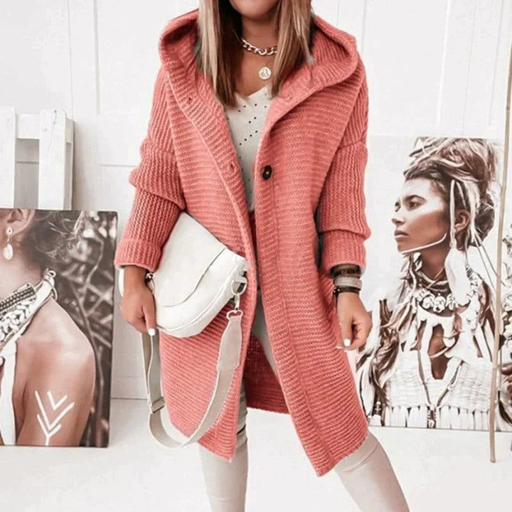 Close-up of a women's cozy knit hooded sweater texture, showcasing comfort & warmth.