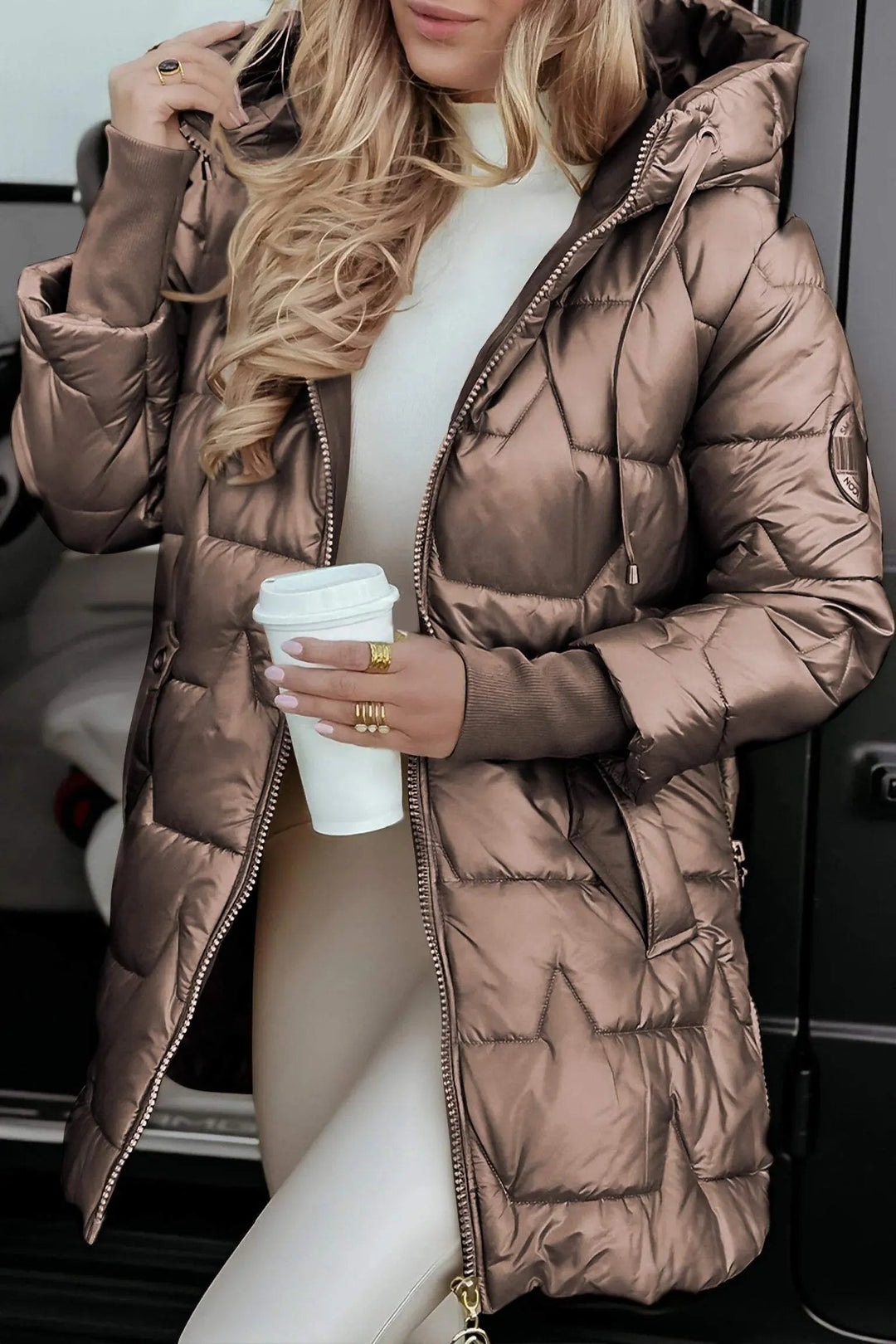 Stylish women's hooded puffer jacket, side view. Perfect for cold weather, autumn, and casual wear.