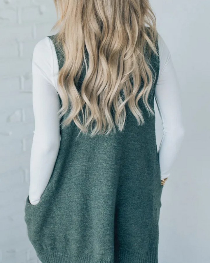 Women's knitwear vest, cozy sleeveless A-line design. Versatile layering for autumn & winter fashion.