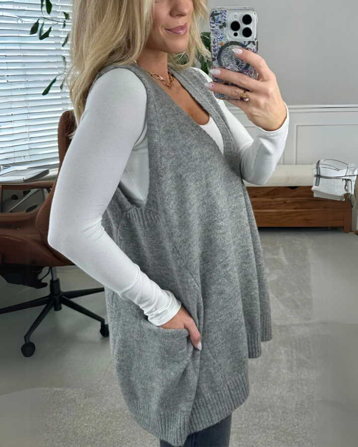 Soft knit women's vest with flattering A-line fit. Cozy, sleeveless, perfect for autumn casual wear.