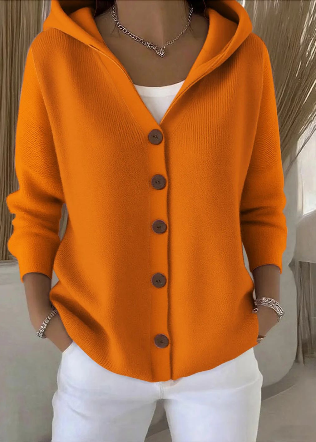 Woman modeling a comfy hooded knit cardigan. Perfect for casual comfort and layering in autumn.