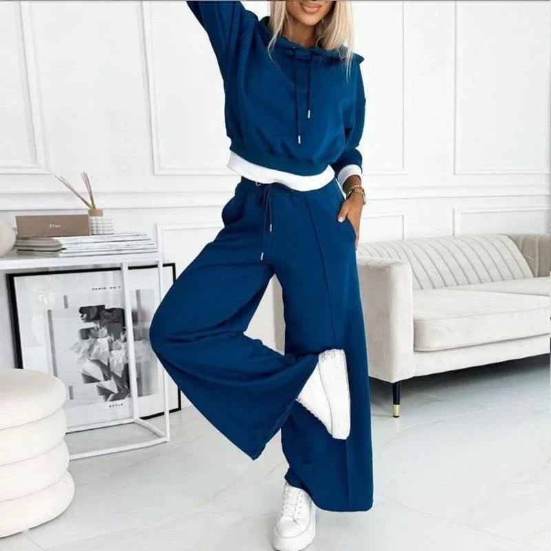 Front view of a woman wearing a relaxed fit knit hoodie and comfortable wide-leg lounge pants outfit.