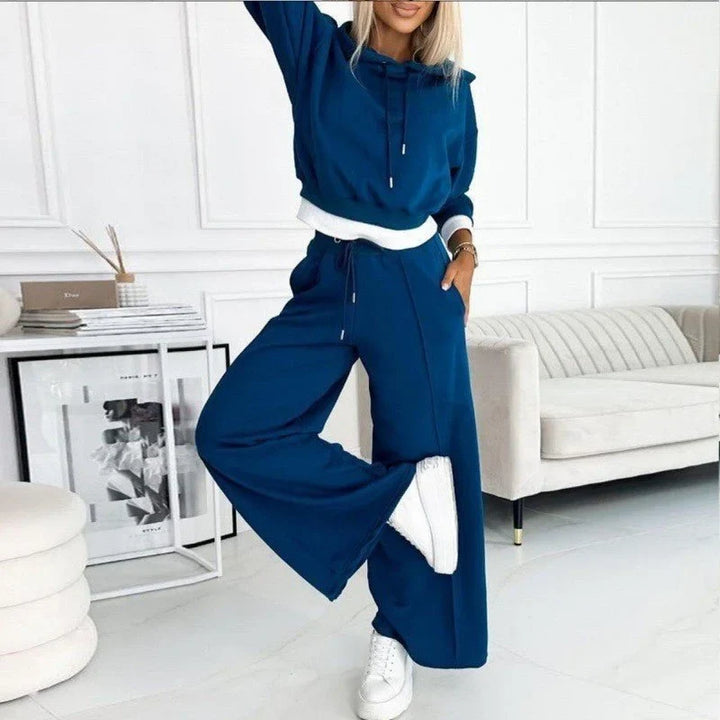 Front view of a woman wearing a relaxed fit knit hoodie and comfortable wide-leg lounge pants outfit.