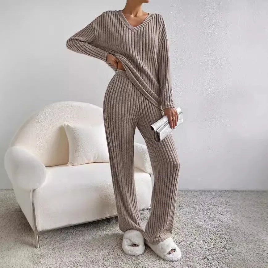 Luxurious women's knit loungewear set, V-neck top & wide leg pants for cozy relaxation.