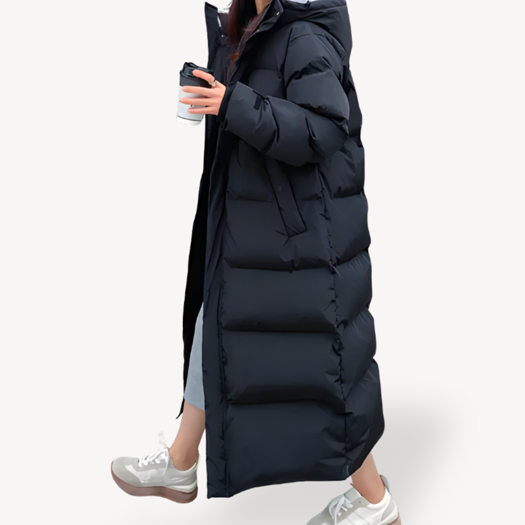 Warm women's long quilted puffer jacket, oversized for comfort, with a cozy hood, ideal for winter outerwear.