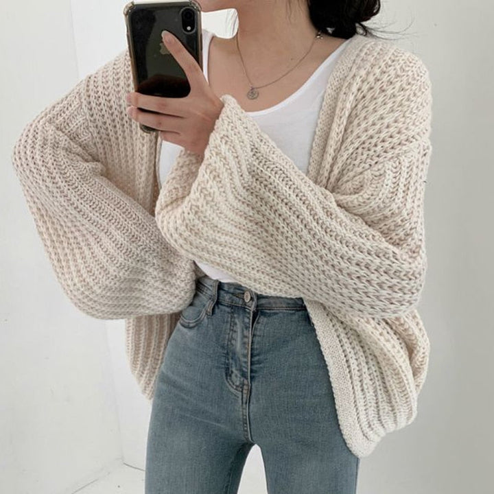 Modern women's oversized open front cardigan with balloon sleeves, offering ultimate cozy comfort.