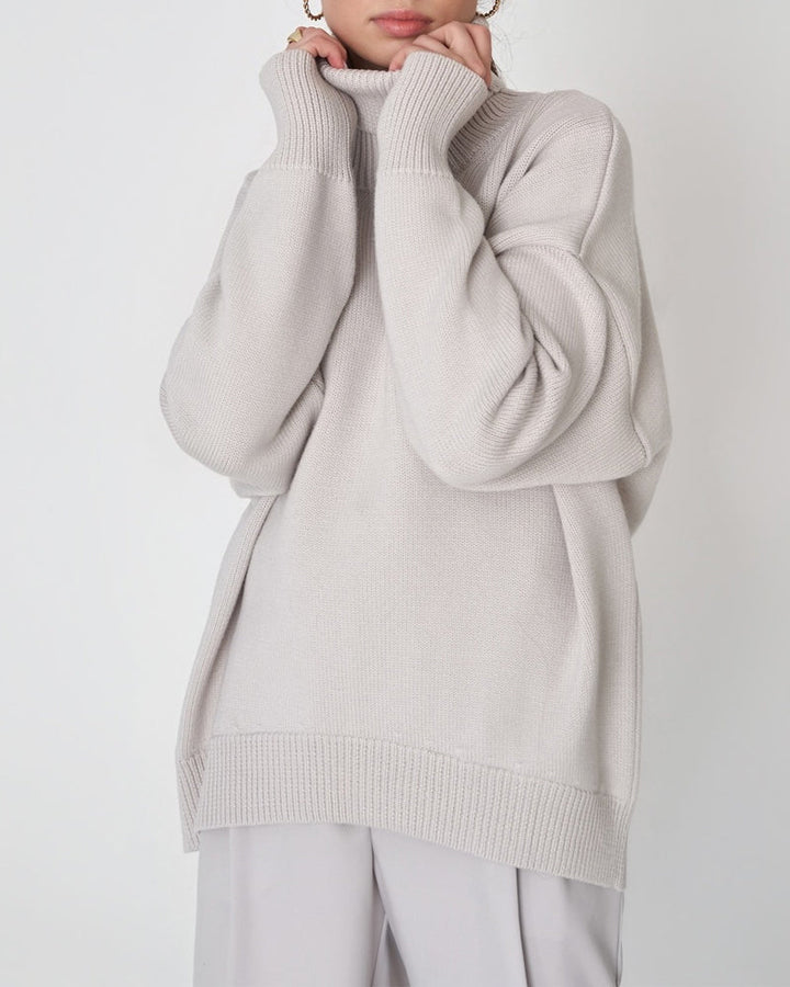 Cozy women's oversized jumper featuring a chic roll neck and comfortable fit.
