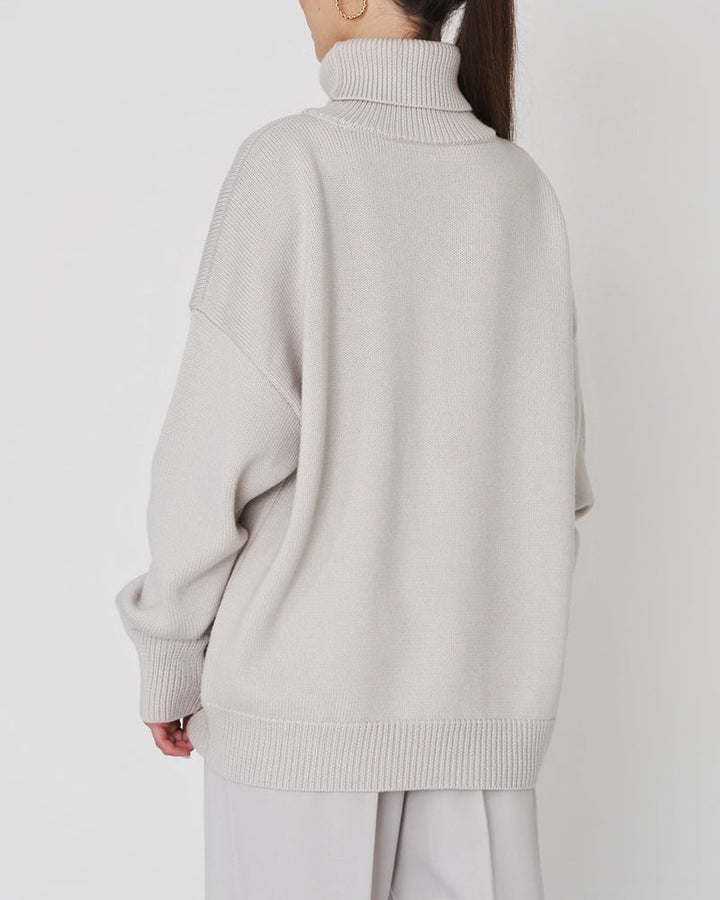 Relaxed fit women's roll neck jumper, a stylish & comfortable choice for cool weather.