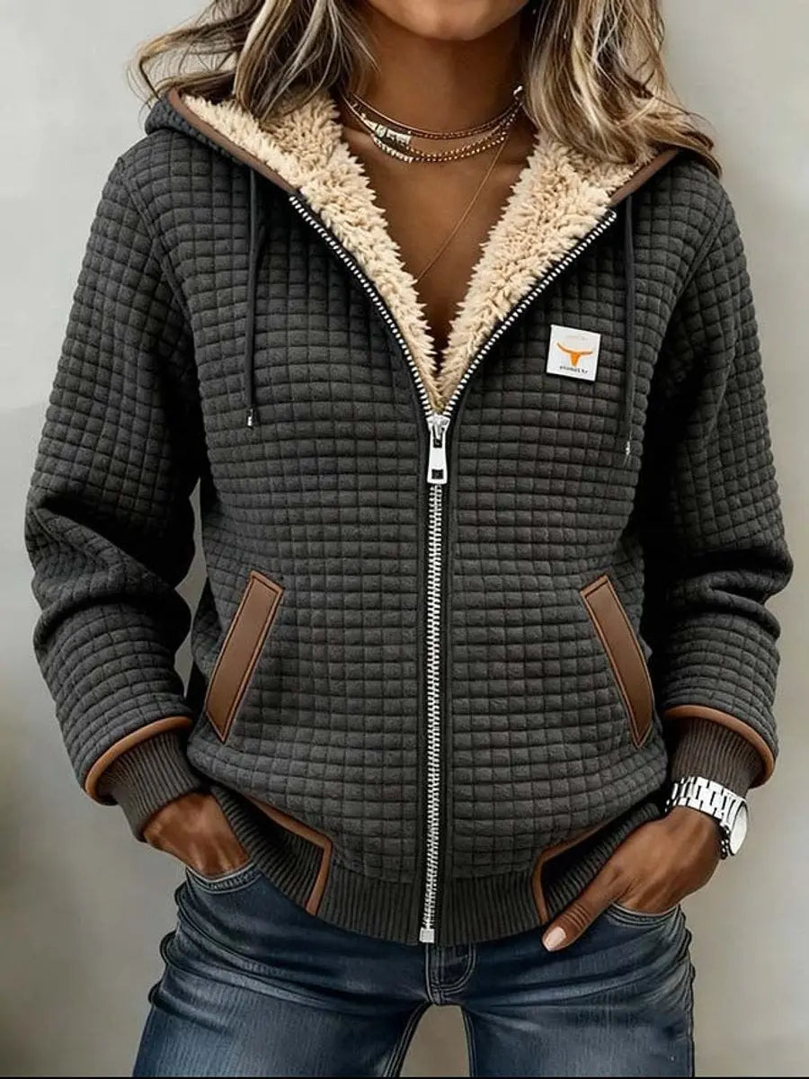 Women's cozy quilted zip-up jacket with hood, lined with soft sherpa fleece for ultimate warmth. Perfect winter outerwear.