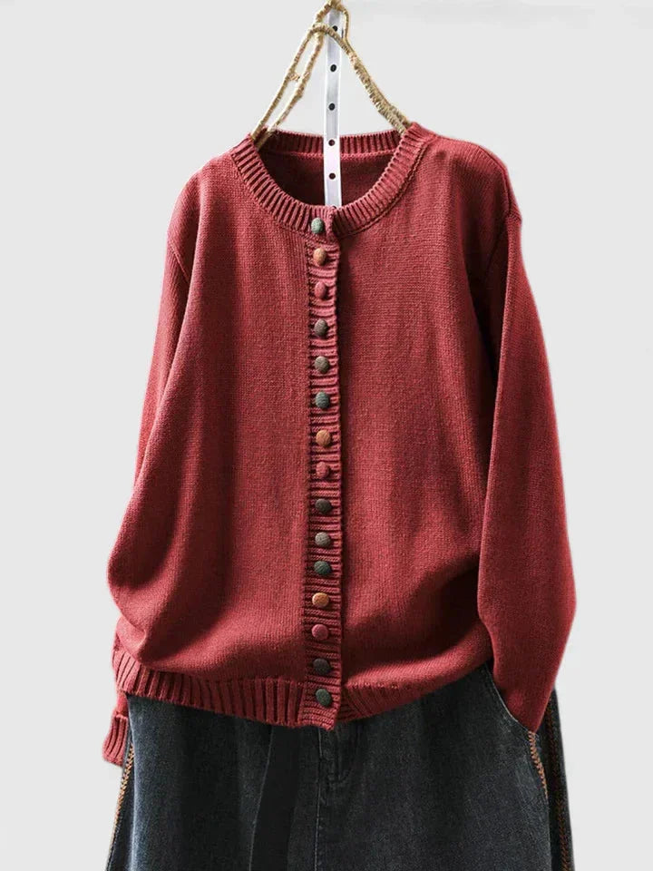 Front view of a women's relaxed-fit button-front cardigan sweater, showcasing its cozy knit and multi-color buttons.