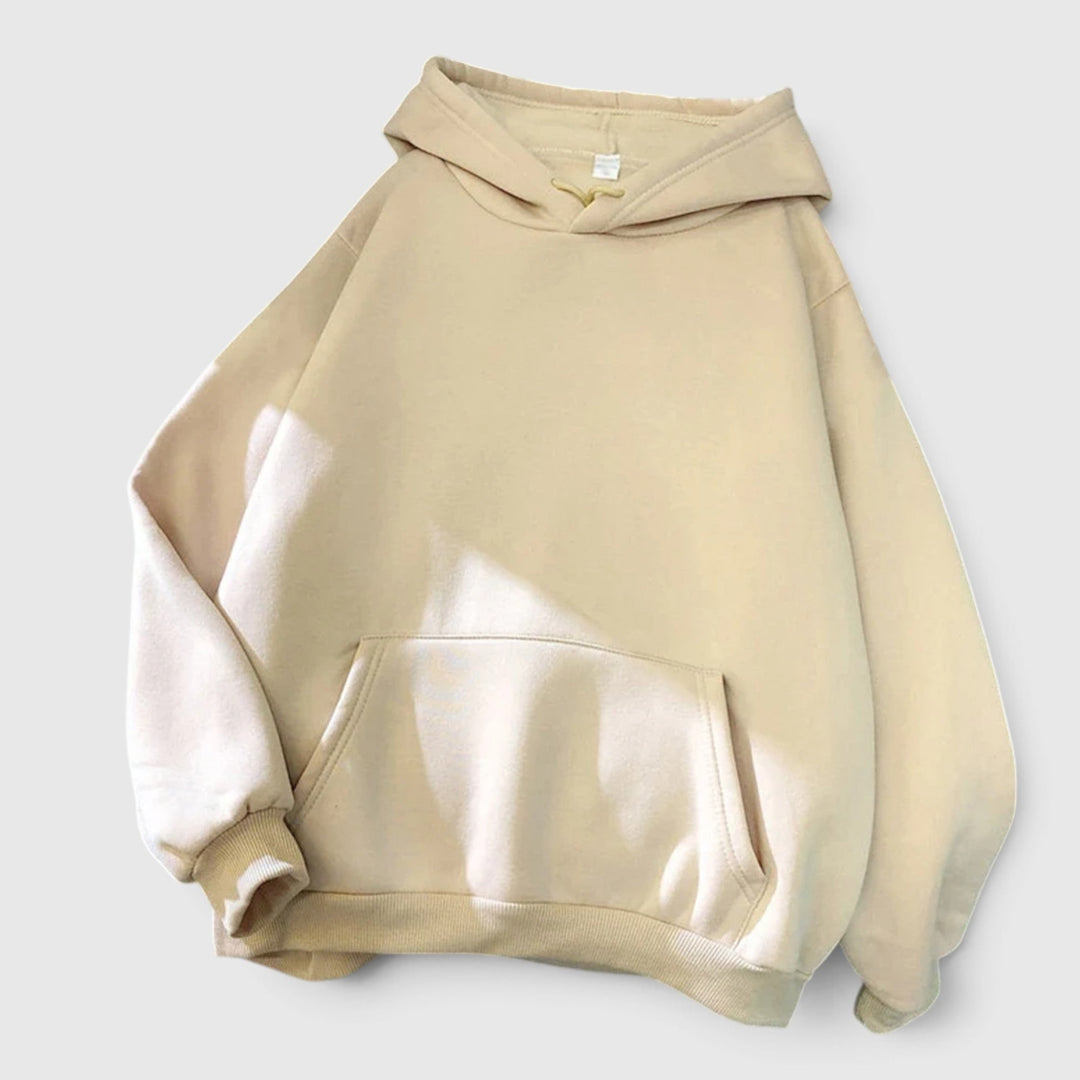 Ultra-cozy women's relaxed fit pullover hoodie. Oversized design with a comfortable kangaroo pocket for warmth.