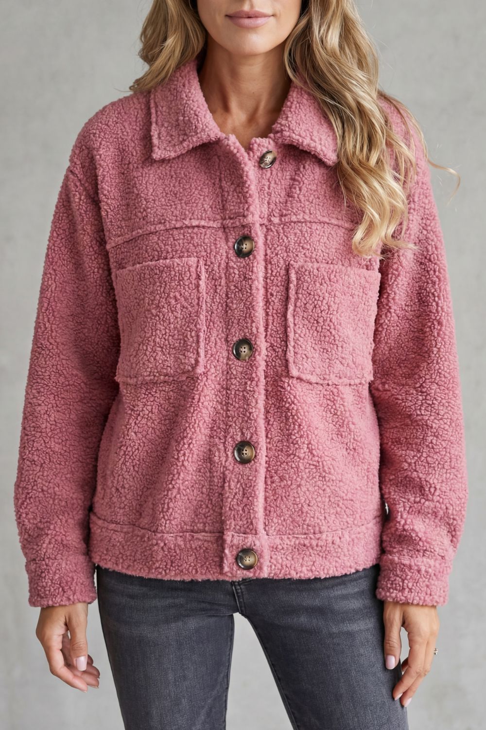 Softly textured women's button-up jacket, providing cozy warmth and stylish outerwear for cooler days.