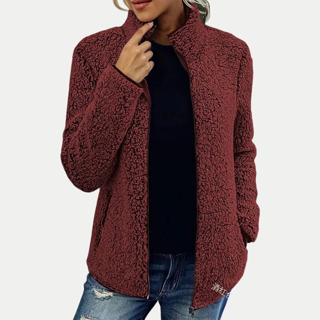 Close-up of women's textured fleece jacket, showing soft fabric & durable zip, perfect for cozy layering.
