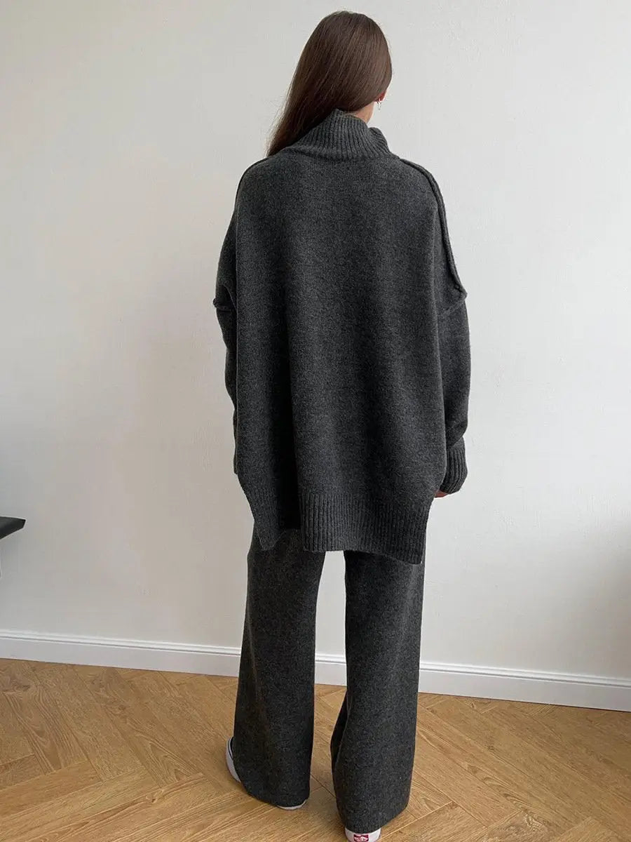 Chic women's knitted turtleneck lounge set with flowing wide leg pants. Ideal for cozy autumn/winter style.