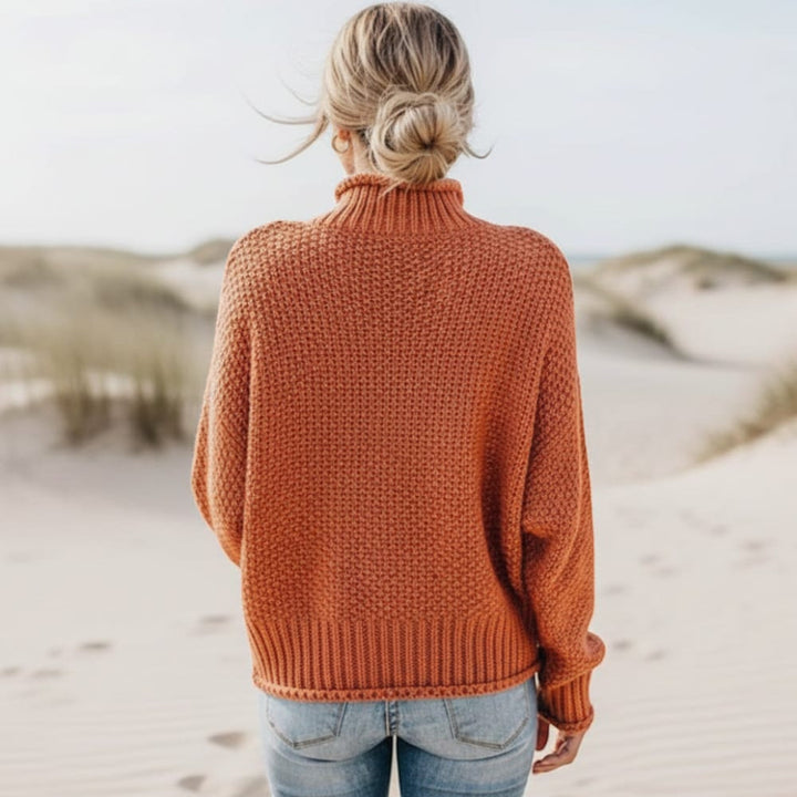 Comfortable women's pullover sweater with cozy turtleneck. Ideal for relaxed fit winter style.