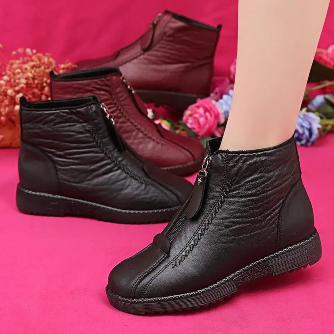 Everyday style women's winter ankle boots. Cozy, round toe design with easy zip-up access for comfort.