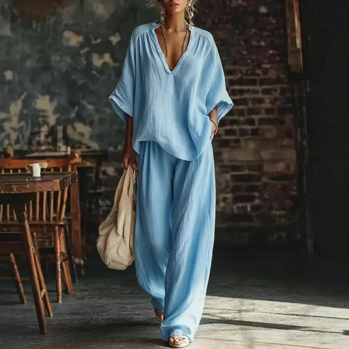 Chic women's crinkled summer set: plunging top & wide-leg pants. Ideal for holidays, beach, or casual outings.