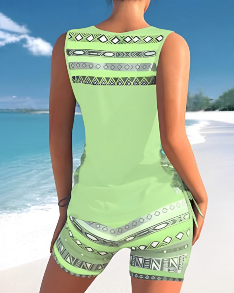 Model posing in a women's criss cross neck printed tankini swimsuit, ideal for beach & sun.