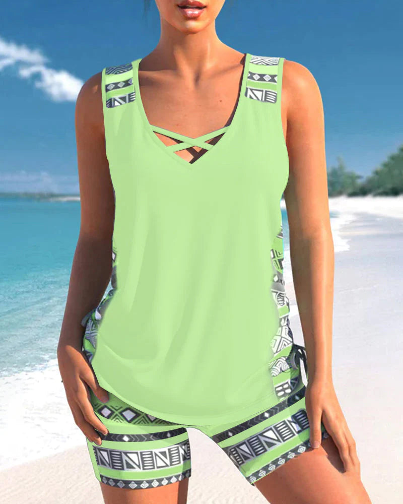 Front view of women's printed tankini two-piece swimwear featuring an elegant criss cross neck.