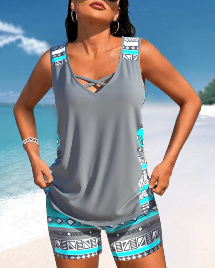Woman enjoying the beach in a fashionable criss cross neck printed tankini two-piece swimsuit.