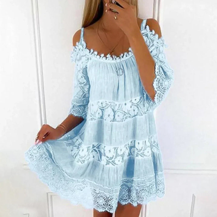 Close-up of delicate crochet lace embroidery on a women's summer mini dress, perfect for beach or casual wear.