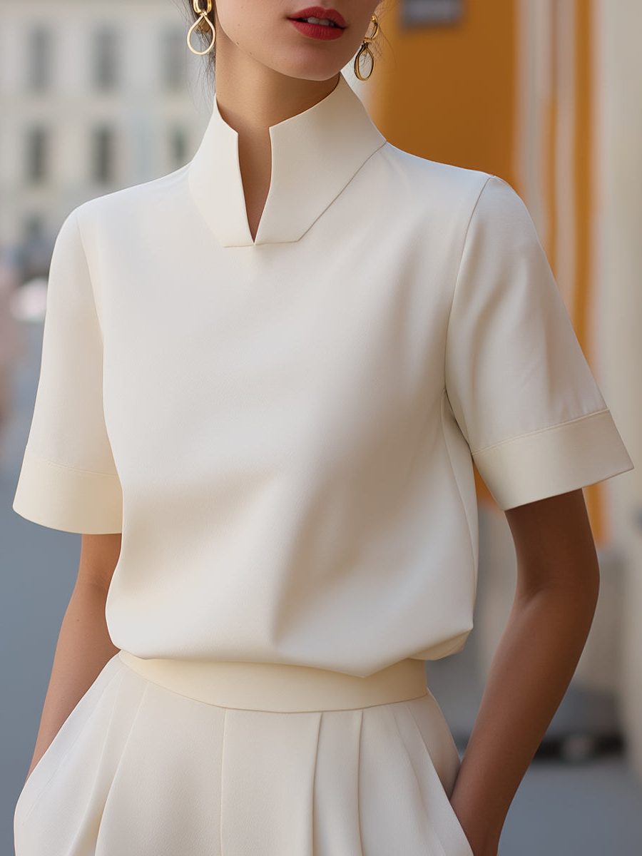 Women's cropped blouse with a stylish stand collar and comfortable short sleeves, perfect for summer fashion.