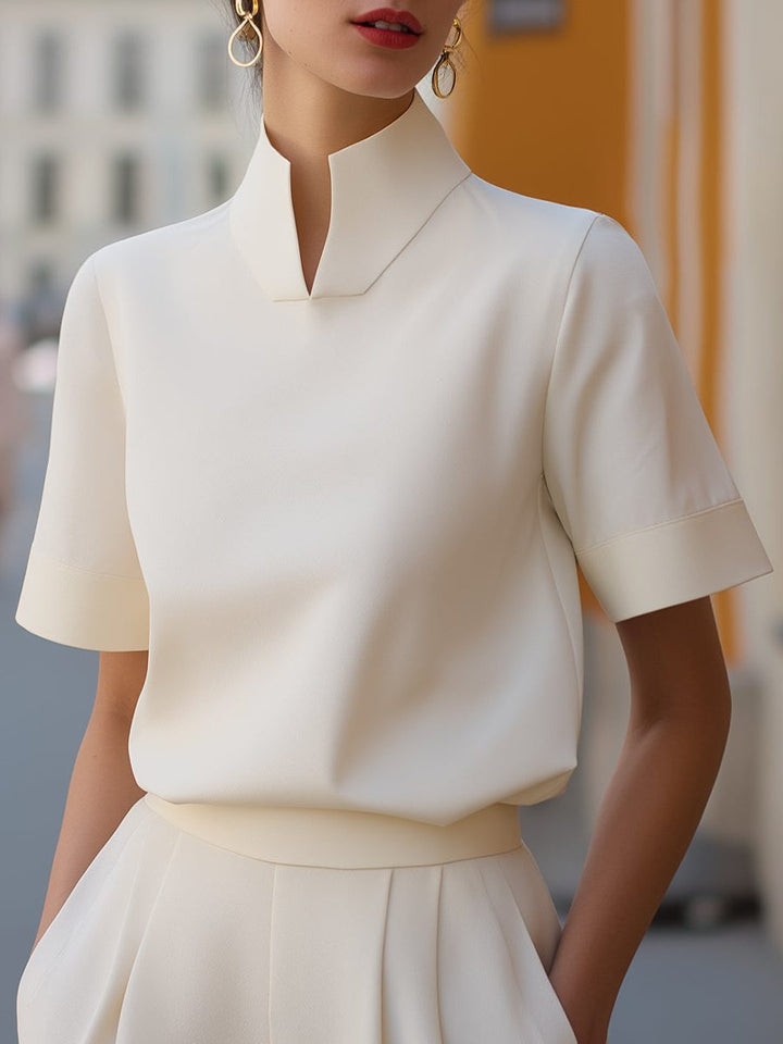 Women's cropped blouse with a stylish stand collar and comfortable short sleeves, perfect for summer fashion.