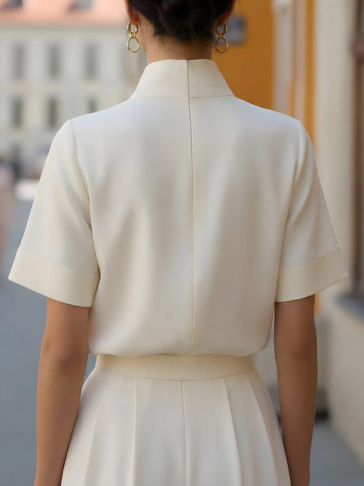 Chic women's cropped blouse, versatile for workwear or casual wear, featuring a modern stand collar.