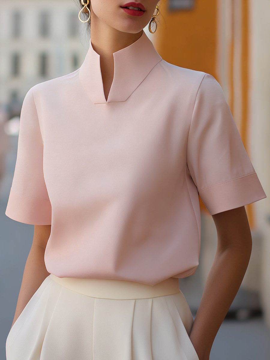 Sophisticated women's blouse; a cropped top with a stand collar and short sleeves for a chic summer style.