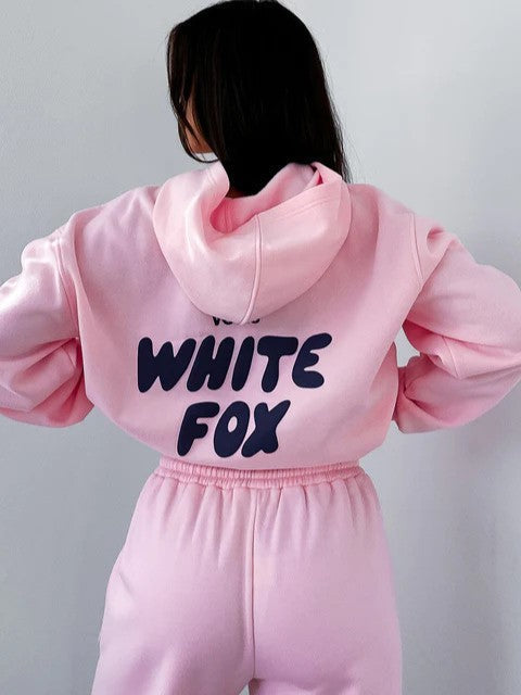 Fashionable women's cropped jogger tracksuit, trendy two-piece set featuring a unique back print.