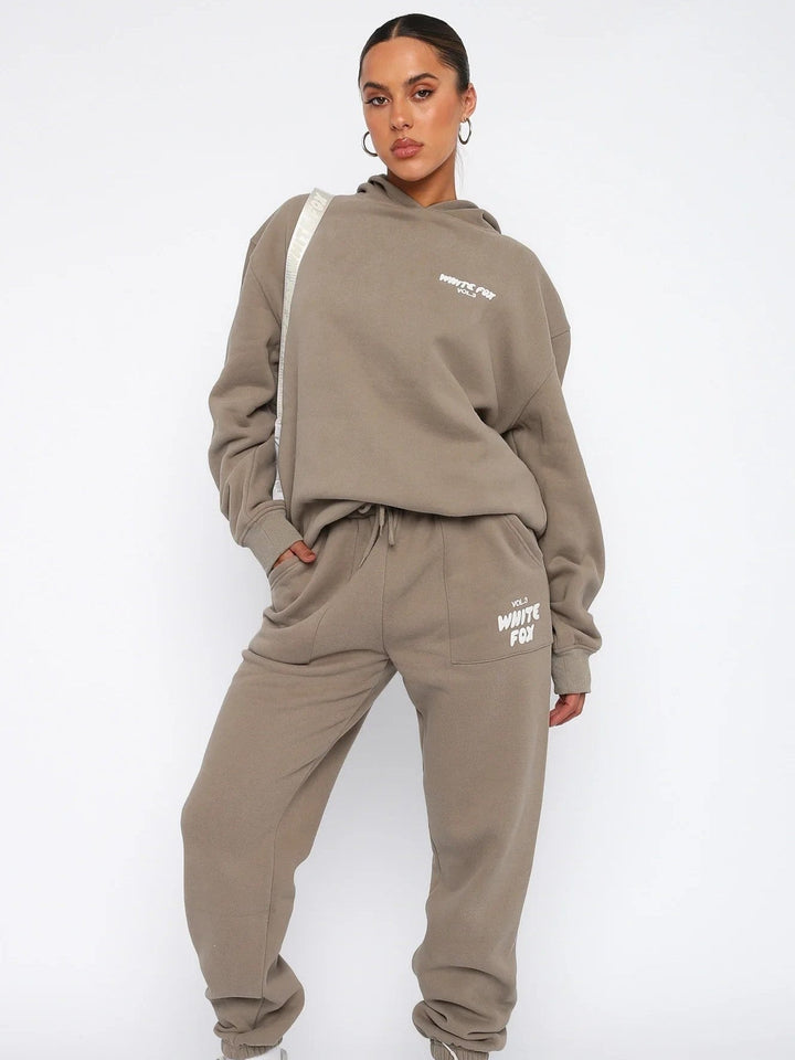 Comfy women's cropped tracksuit, a relaxed two-piece set with a stylish unique back print detail.
