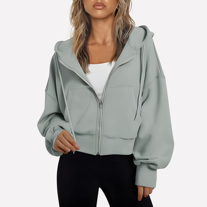 Stylish women's cropped drawstring hoodie with a practical zip, offering a relaxed fit.