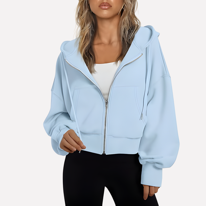 Fashionable women's cropped zip hoodie, ideal for layering with its drawstring design.