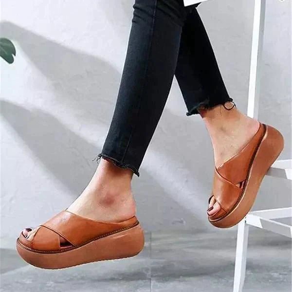 Cushioned footbed women's flat sandals with stylish cross straps. Slip-on for easy, comfortable summer wear.