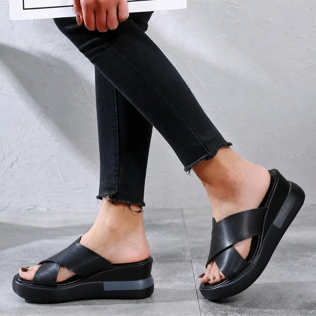 Versatile women's cushioned flat sandals with elegant cross straps. Ideal comfort footwear for summer & holidays.