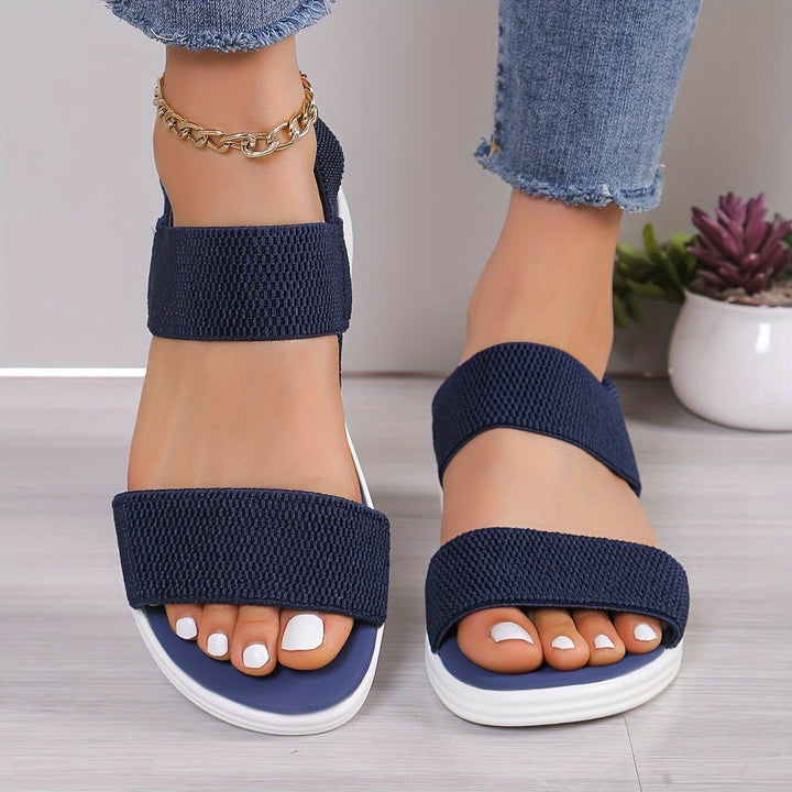 Stylish women's slip-on cross-strap platform sandals, offering cushioned comfort for everyday summer wear.
