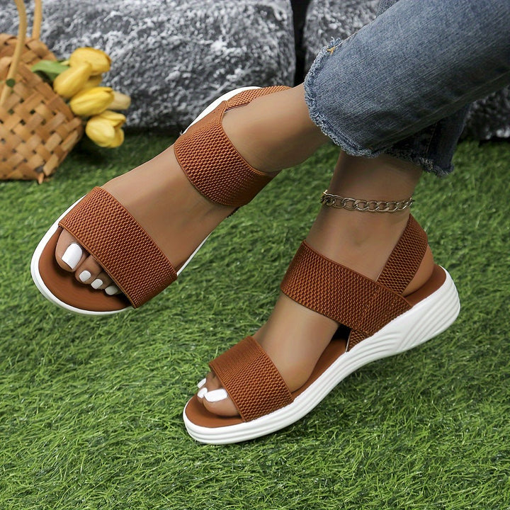 Stylish women's cushioned platform sandals with comfortable elastic cross-straps, ideal for everyday wear.