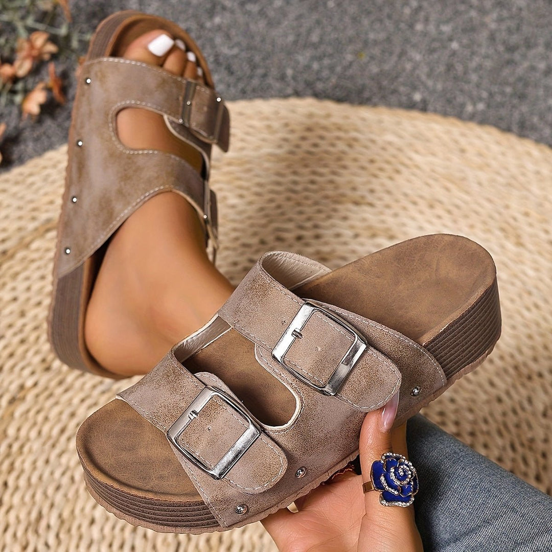 Women's cushioned cross-strap platform sandals with a supportive sole & adjustable buckle.