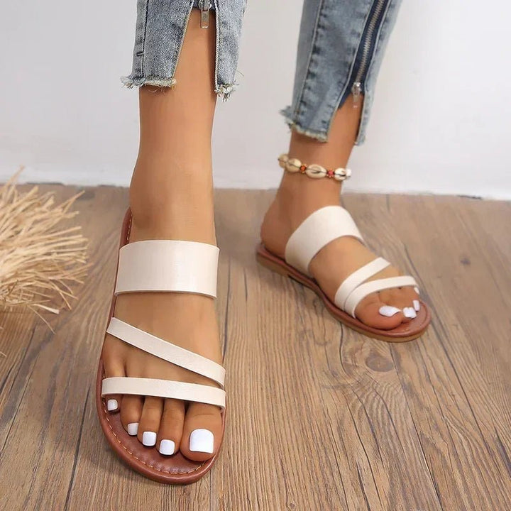 Stylish women's summer sandals, slip-on design with cushioned cross-straps for ultimate comfort.