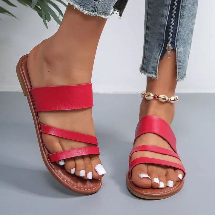 Women's cushioned cross-strap slip-on sandals, designed for casual comfort and everyday wear.