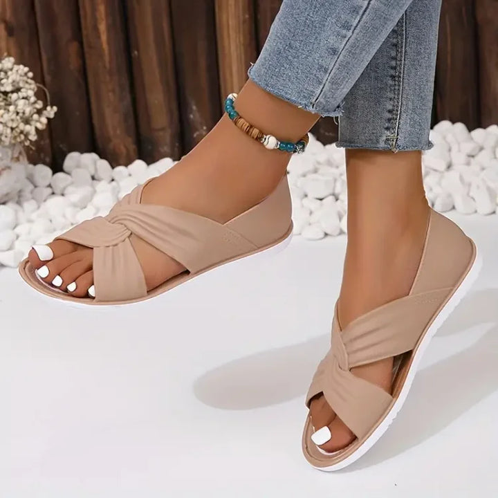Women's cushioned crossover sandals in tan for all-day comfort and arch support.