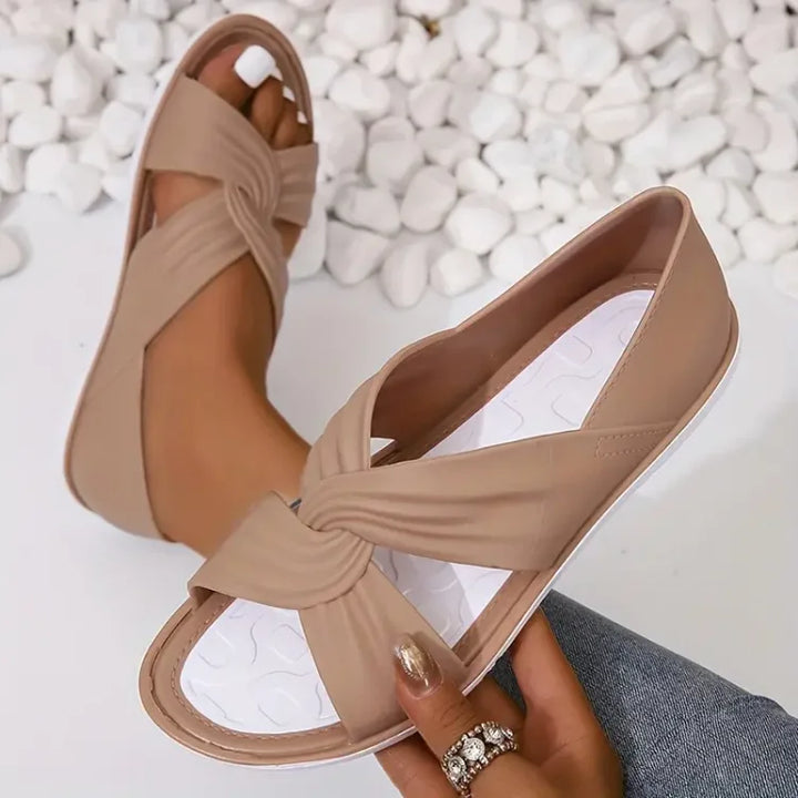 Stylish women's slip-on crossover sandals with soft cushioning, perfect for summer.