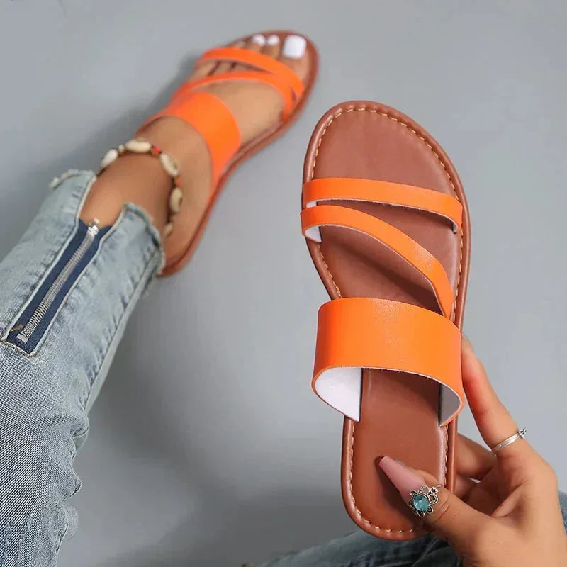 Stylish women's cushioned flat sandals. Multi-strap, open-toe, slip-on design for comfortable summer and vacation footwear.