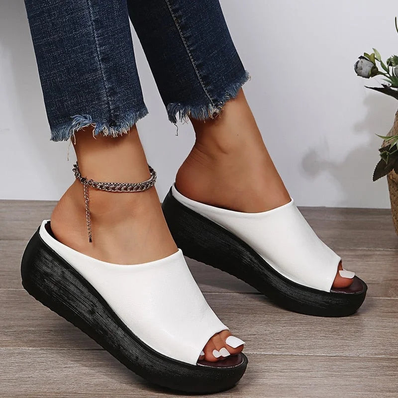 Comfortable women's platform sandals with a cushioned wide strap. Stylish open-toe slip-ons for summer casual.