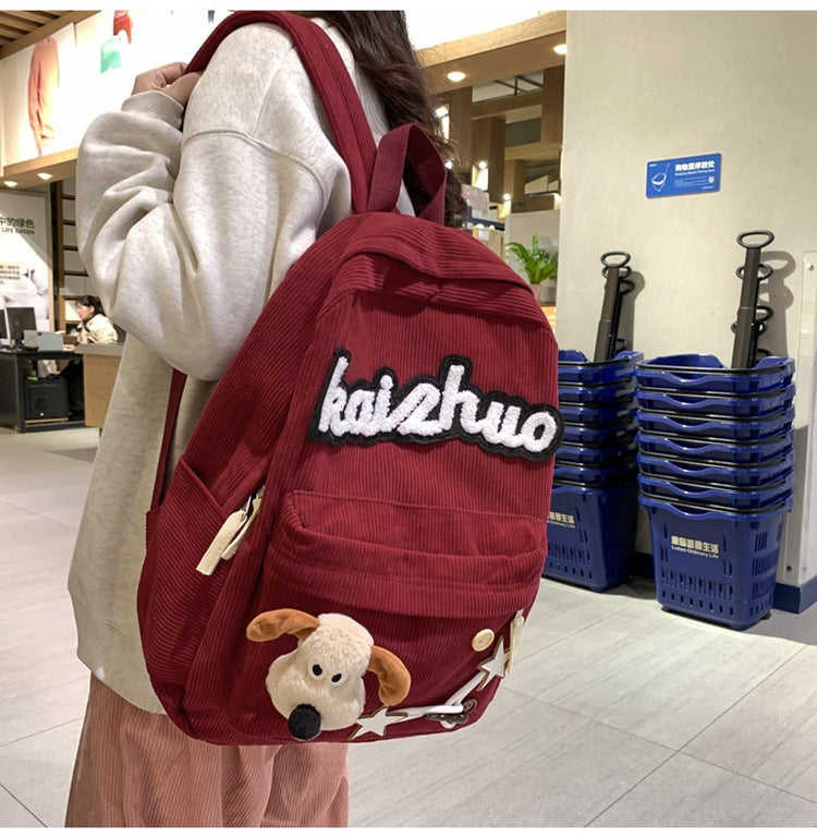 Trendy women's backpack adorned with cute, colorful appliqués, a fun and stylish choice for students & daily errands.