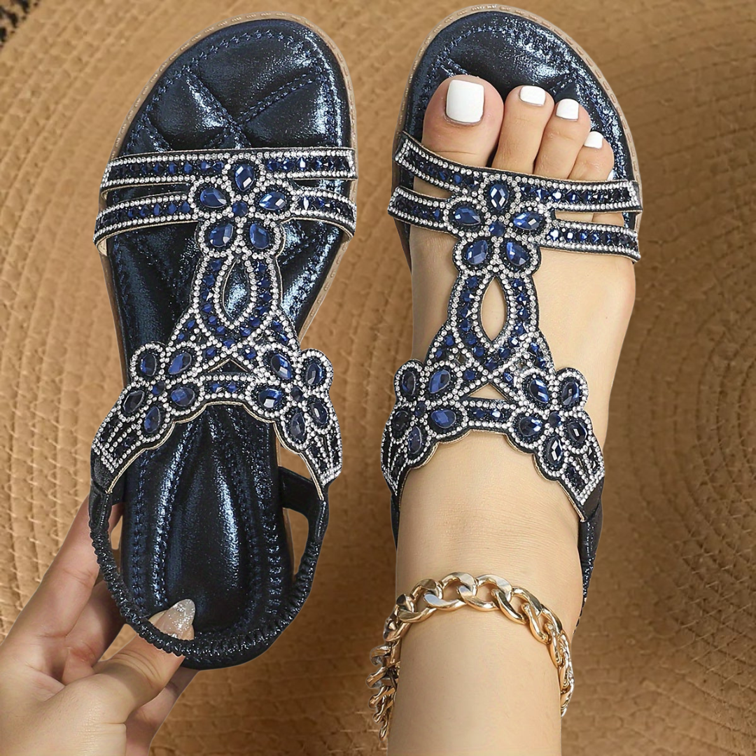 Dazzling women's flat sandals featuring brilliant rhinestones, offering summer comfort & style.
