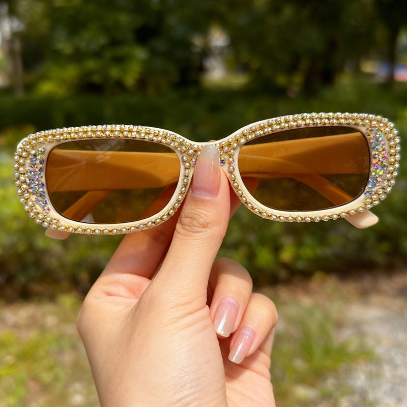 Stylish women's sunglasses with UV protection, oversized frames & dazzling rhinestones for trendy fashion.