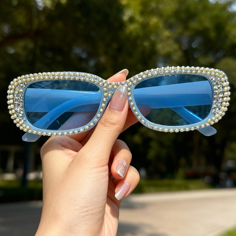 Dazzling women's oversized fashion sunglasses adorned with sparkling rhinestones, perfect for elegant style.
