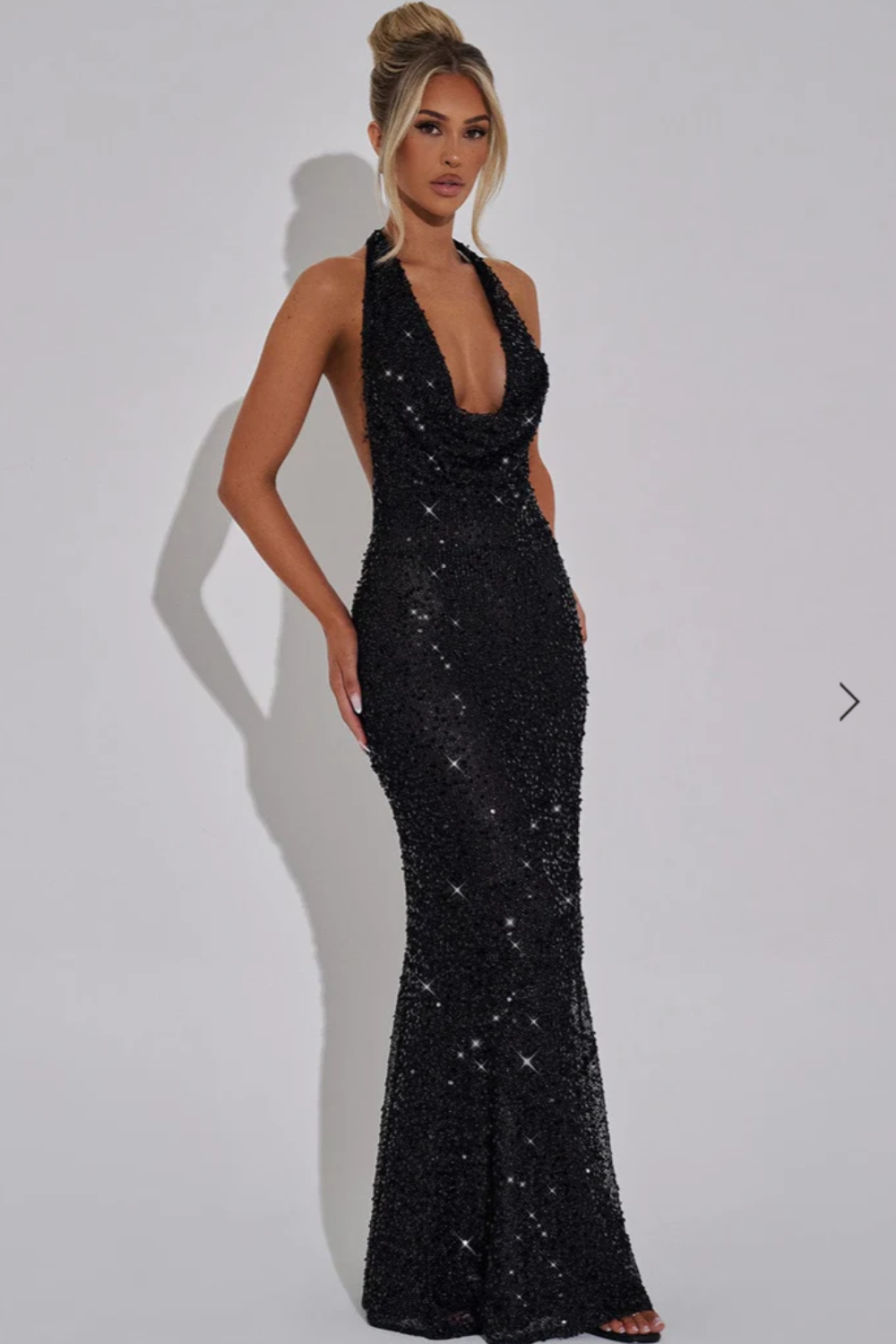 Elegant women's sequin maxi dress with a sophisticated halter neck and open back design.