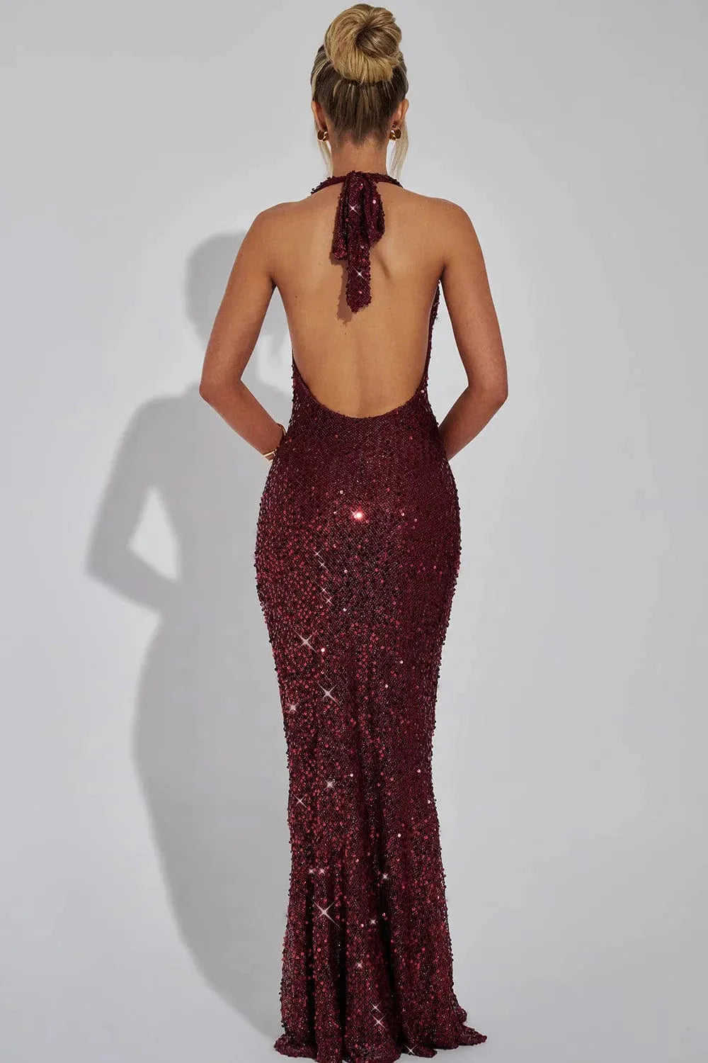 Women's elegant sequin maxi dress, featuring a chic open back and a dazzling finish.